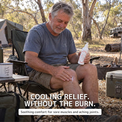 A man sitting in a folding camp chair outdoors in a wooded campsite setting, applying pure and natural pain relief cream from a white bottle to his knee. Text overlays read 'COOLING RELIEF.